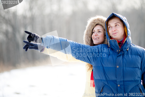 Image of Young couple walking in a park. Winter season.