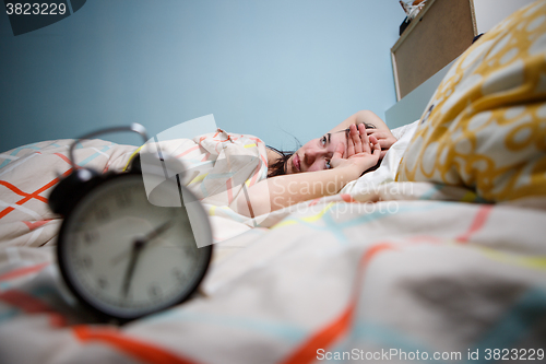 Image of Woman with insomnia touching her head