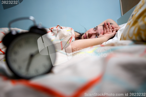 Image of Woman with insomnia touching her head