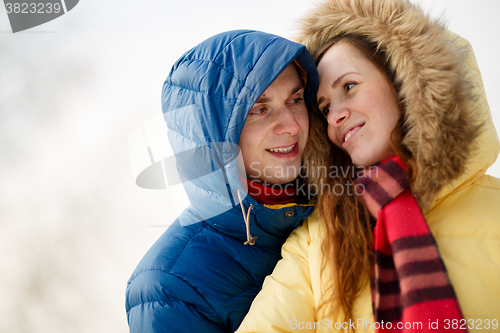 Image of Couple smiling, hugging 