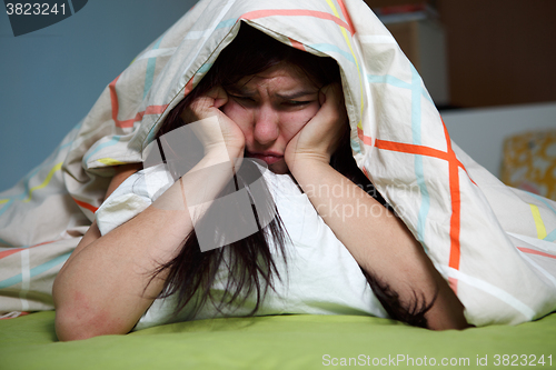 Image of Woman with blanket under her head