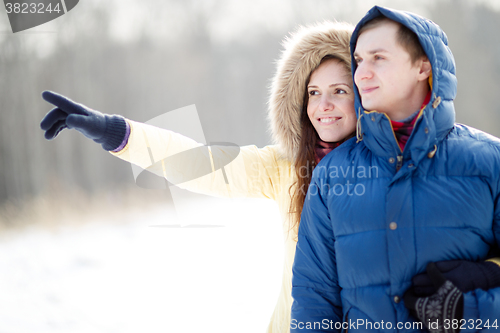 Image of Young couple walking in a park. Winter season.