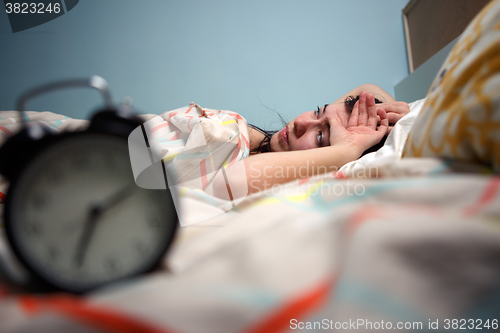 Image of Woman with insomnia touching her head