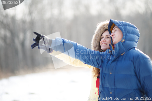 Image of Young couple walking in a park. Winter season.