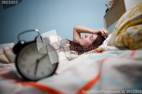 Image of Woman with insomnia touching her head