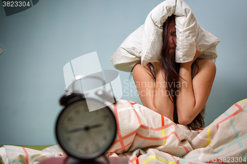 Image of Woman with a pillow over head.