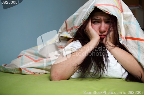 Image of Woman with blanket under her head