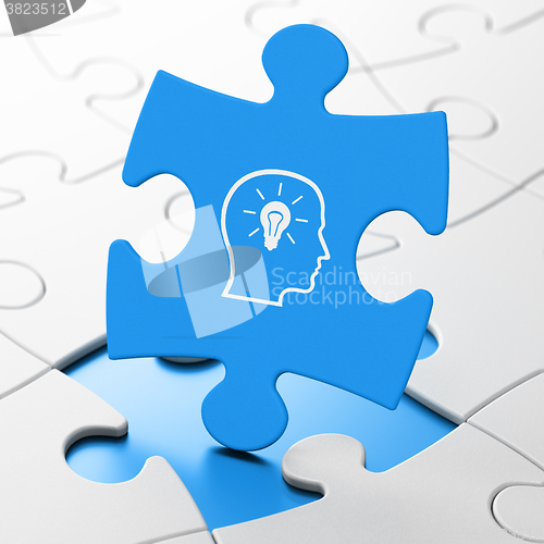 Image of Marketing concept: Head With Lightbulb on puzzle background