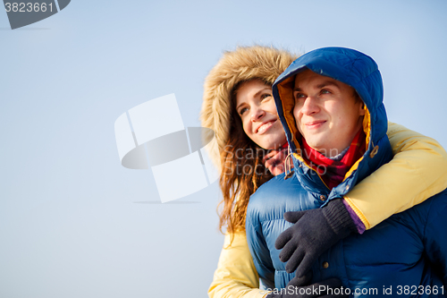 Image of beautiful couple embracing in winter