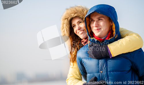 Image of beautiful couple embracing in winter