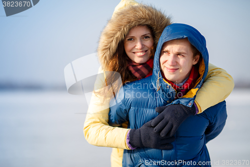 Image of beautiful couple embracing in winter