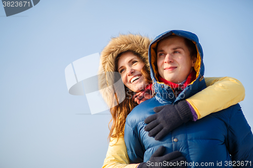 Image of beautiful couple embracing in winter