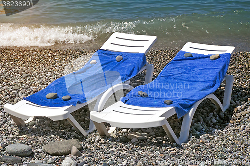 Image of Two sun loungers for relaxing by the sea.