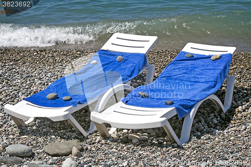 Image of Two sun loungers for relaxing by the sea.