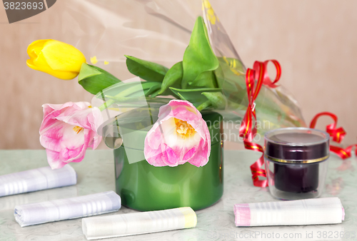 Image of Cosmetics for body and hair and flowers.