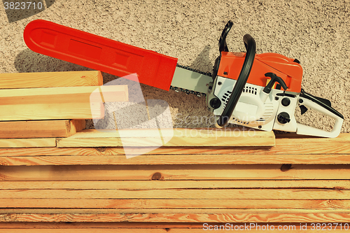 Image of Chainsaw and lumber.