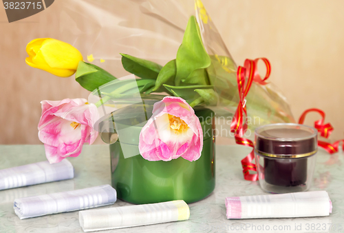 Image of Cosmetics for body and hair and flowers.
