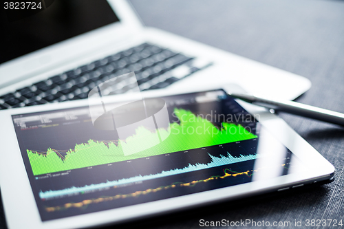 Image of Digital tablet with stock market graph