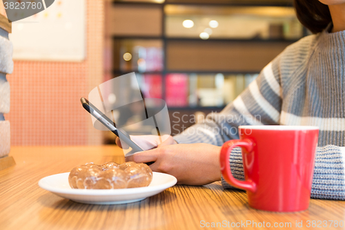Image of Woman use of the cellphone at coffee shop