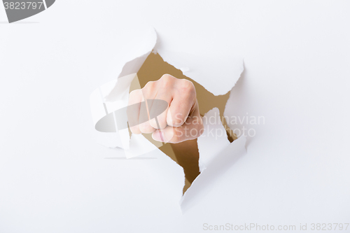 Image of Paper breakthough by woman punch