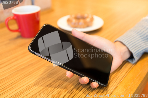 Image of Woman hand holding blank screen of cellphone