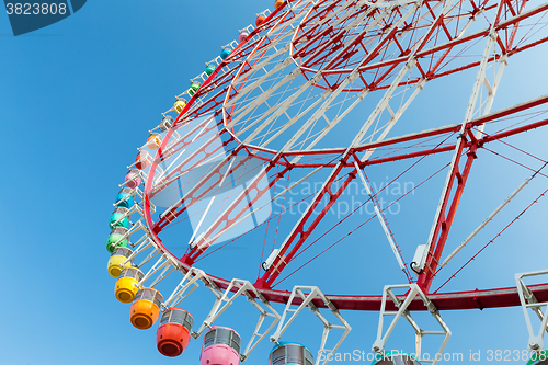 Image of Ferris wheel in carnival with blue sky