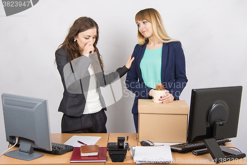 Image of Office worker with tears accompanies the dismissed colleague