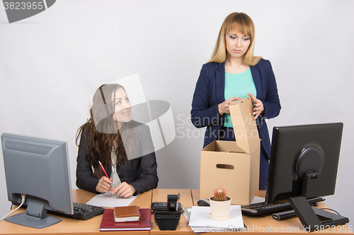 Image of Office staff member with a smile watching fired colleague