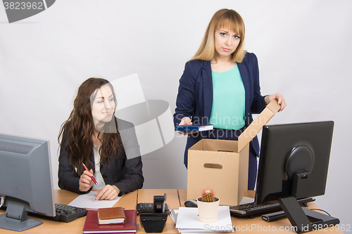 Image of Office staff member with a smile watching charges fired colleagues