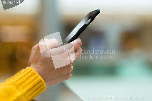 Image of Woman uses her smart phone on the street