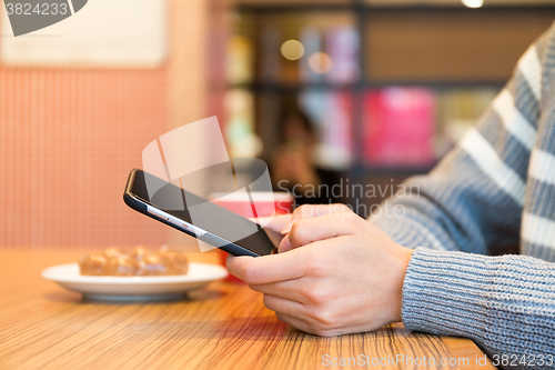 Image of Woman typing on mobile phone