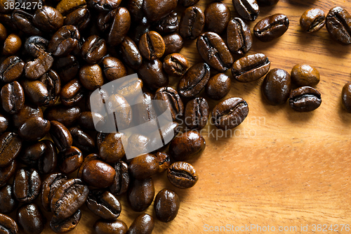 Image of Roasted coffee bean against wooden background