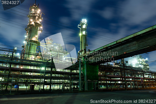 Image of Complex network of pipes in factory at night