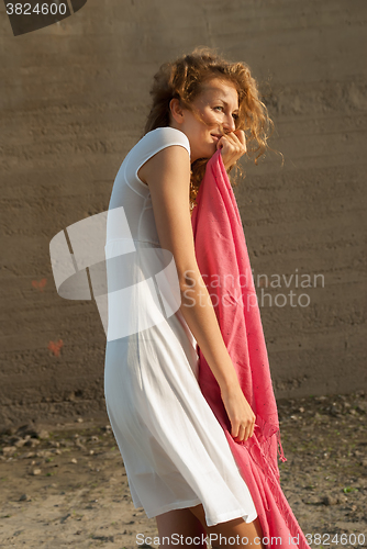 Image of Young pretty woman with red scarf