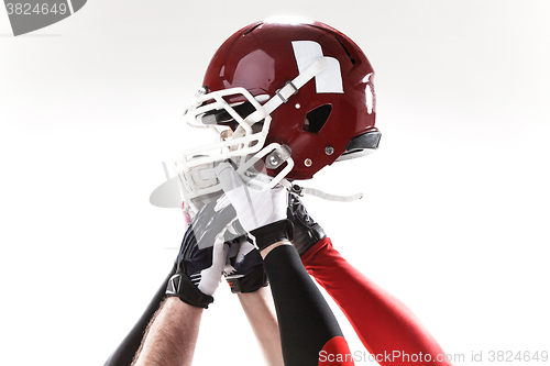 Image of The hands of american football players with helmet on white background