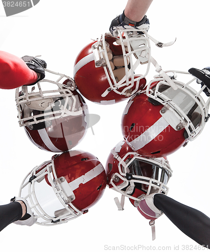 Image of The hands of american football players with helmets on white background