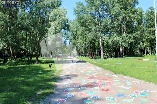 Image of People have a rest in park with big trees