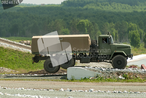 Image of Curtain sided truck comes around on high obstacle