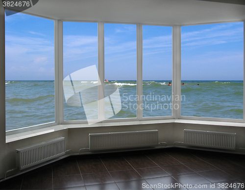 Image of plastic window with view of marine waves