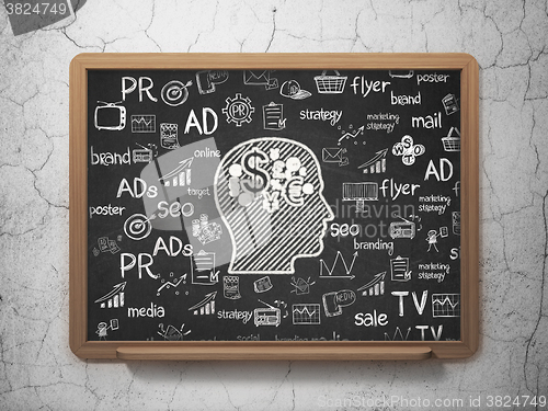 Image of Advertising concept: Head With Finance Symbol on School Board background