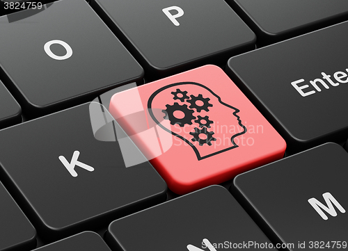 Image of Marketing concept: Head With Gears on computer keyboard background