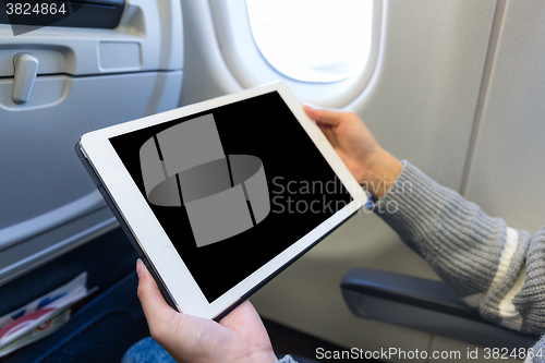 Image of Woman use of the digital tablet in plane