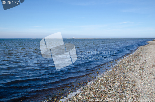 Image of Shoreline with blue water and pebbles