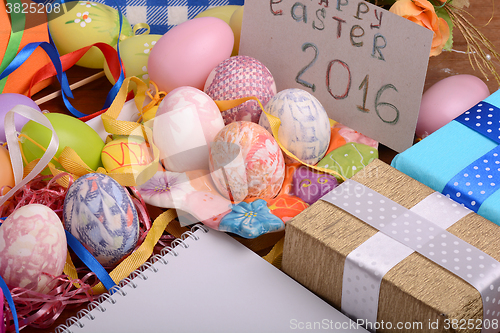 Image of hand made eggs at a gift box, happy easter invitation card