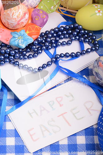 Image of Easter eggs and invitation note. happy easter