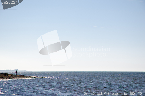 Image of Man silhouette by the coast