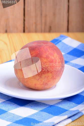Image of fresh peach on white plate