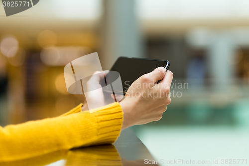 Image of Closeup of female hand using smart phone