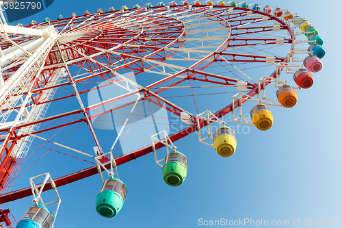 Image of Ferris wheel with blue sky