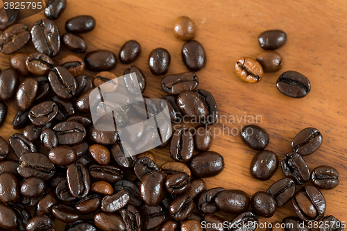 Image of Coffee bean against wooden background